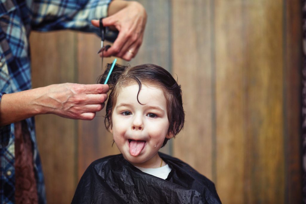 giving young autistitc child haircut