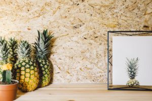 decorative pineapples against a minimalistic wall