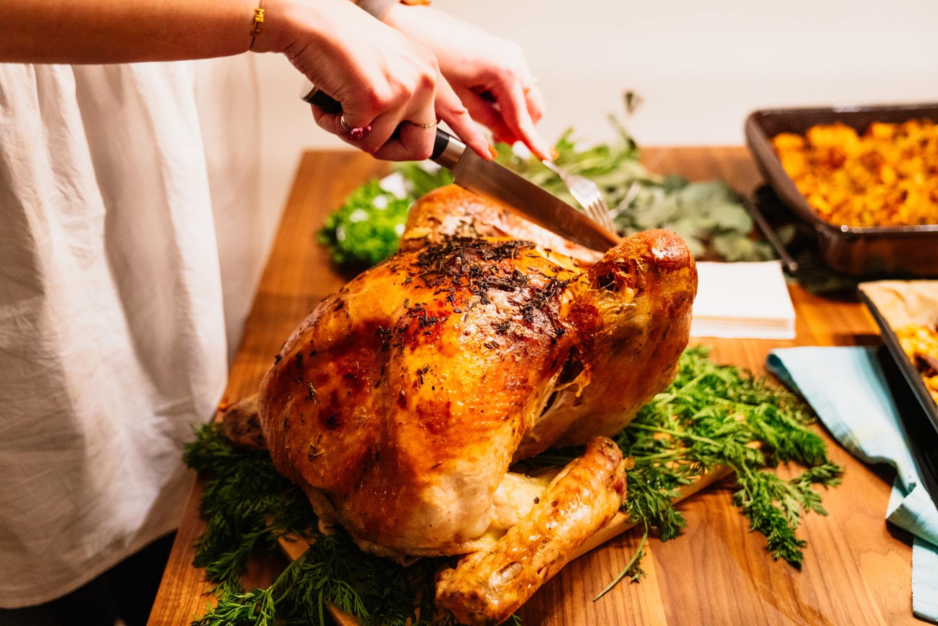 carving a golden thanksgiving turkey